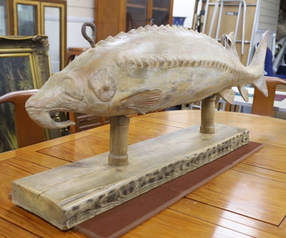 A carved wood sturgeon, on wood stand, length 140cm